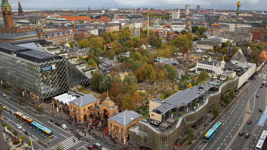 Looking across Tivoli Gardens in Copenhagen: rides among the trees, the city behind.